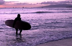 All in a Day's Work. Image of surf instructor at sunset, ... by Glenn Poulain 
